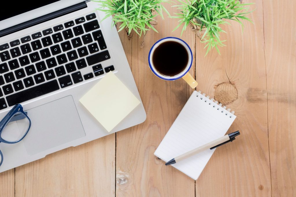 A notebook next to a cup of tea