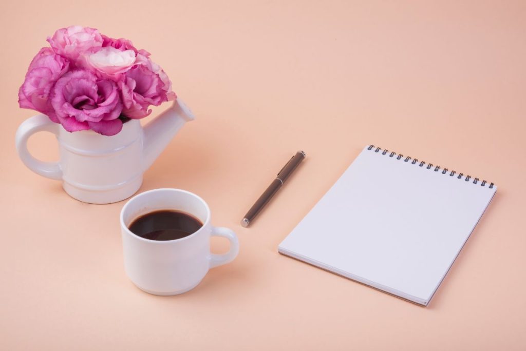  A to-do list and a cup of coffee on a clean, organized desk—signifying planning and prioritizing tasks in the morning